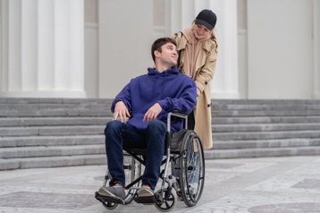 Picture of a woman pushing her date in a wheelchair around 