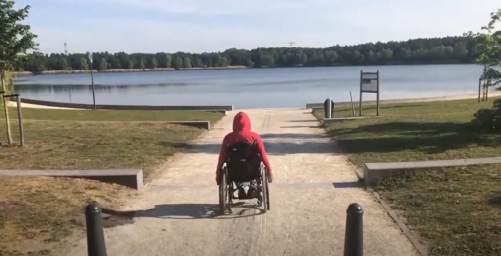Me from behind in my wheelchair with a huge lake in front of me