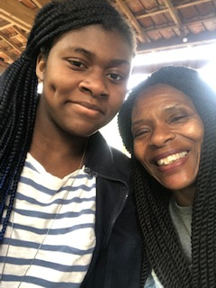 A selfie of me and my mother both smiling at the camera.